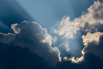 Sun beams breaking through the dark clouds