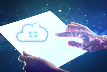 Hand holdig futuristic tablet with 5G inscription, modern technology concept
