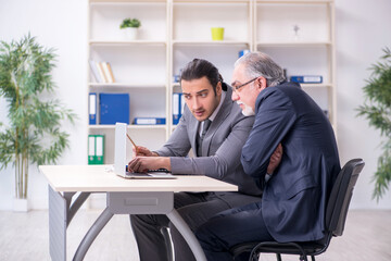 Old and young businessmen in business meeting concept