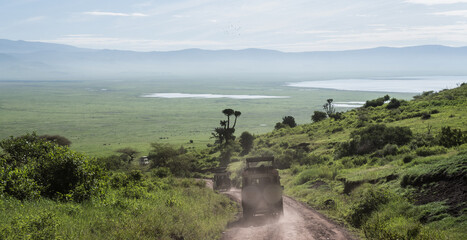 Safari truck driving into the Ngorongoro crater with view over the lakes © Niels