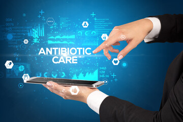 Close-up of a touchscreen with ANTIBIOTIC CARE inscription, medical concept