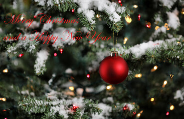 Christmas ornament with snowy fir branches and lights. Winter decoration background plus text message