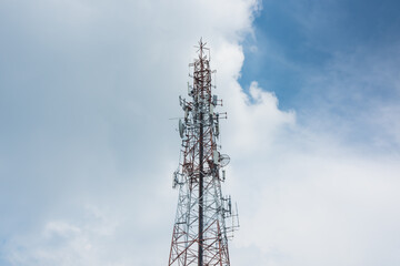 Upper view of communication pole with the clouds fill the sky background