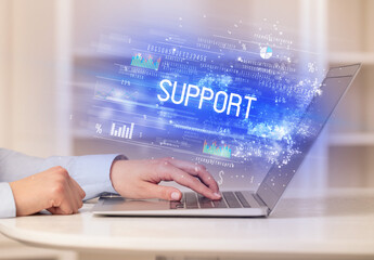 Closeup of businessman hands working on laptop with SUPPORT inscription, succesfull business concept