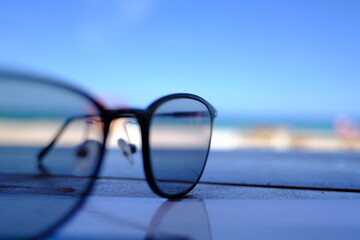 black sunglasses and sea background. Holidays and vacations by the ocean