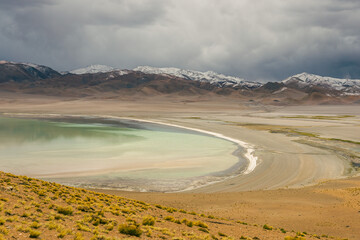 Light green crater lake in the mountains