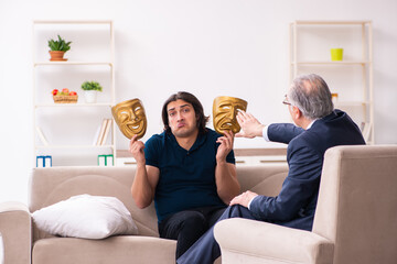 Young man wearing masks during psychotherapy session