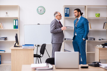 Two male colleagues working in the office