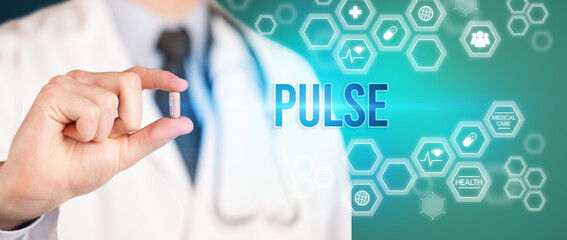 Close-up of a doctor giving you a pill with PULSE inscription, medical concept
