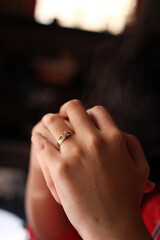 Young women hand together and showing engagement ring closeup view with dark background, Women hand with engagement ring close up