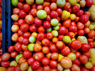 Pile of Red Small Tomatoes for Sale at Supermarket