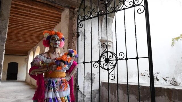 Catrina woman walking in old house with flowers on her head