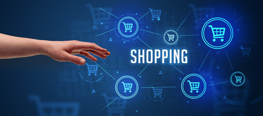 Close-Up of cropped hand pointing at SHOPPING inscription, online shopping concept