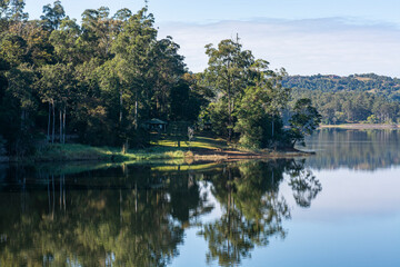 Obraz premium Early morning reflections on Baroon Pocket Dam. Queensland, Australia.
