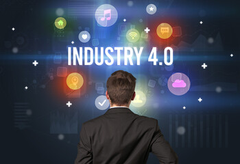 Rear view of a businessman with INDUSTRY 4.0 inscription, modern technology concept