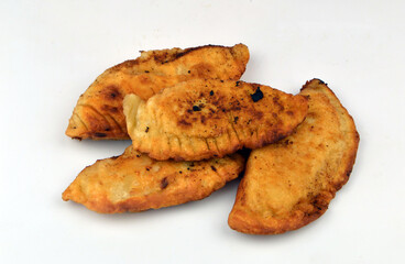 
fresh fried pasties lie on a white plate