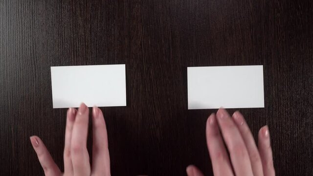 Female hands move cards. White isolate.