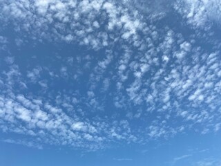 Broken white clouds on a blue sky.