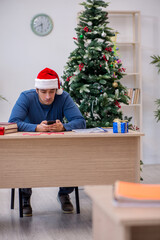 Young male student preparing for exams during new year celebrati