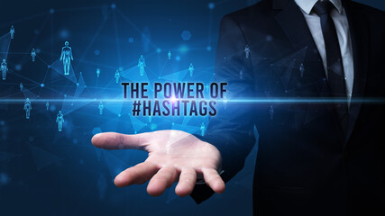 Elegant hand holding THE POWER OF #HASHTAGS inscription, social networking concept