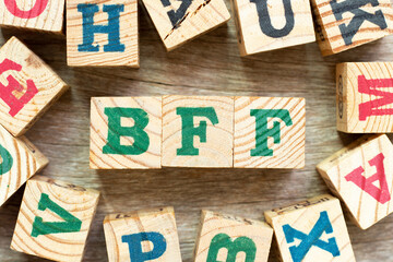 Alphabet letter block in word BFF (Abbreviation of best friend forever) with another on wood...