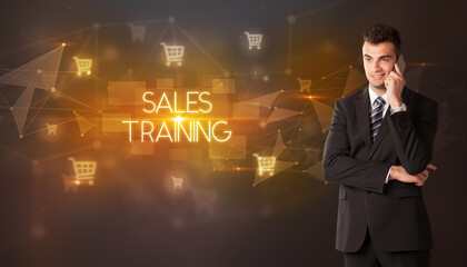 Businessman with shopping cart icons and SALES TRAINING inscription, online shopping concept
