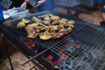 BBQ Honey Chicken, Malaysian food is on the grill with smoke.
