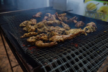 BBQ Honey Chicken, Malaysian food is on the grill with smoke.