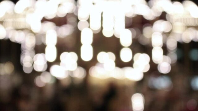 Blurry moving lights of carousel in front of Hotel De Ville in Paris.