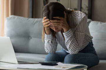 Unhappy young woman manage family household finances feel distressed with bankruptcy. Upset female pay bills online stressed frustrated by financial debt or money loss, think of problem solution.
