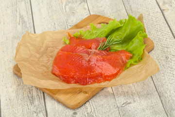 Sliced salmon fillet served rosemary