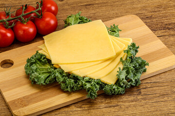 Sliced Gauda cheese over board