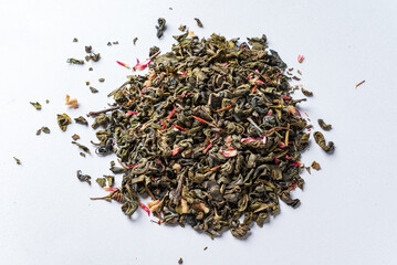 green tea with petals on white background