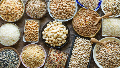 Variety kinds of dry organic white and brown cereal and grain seed on grunge background