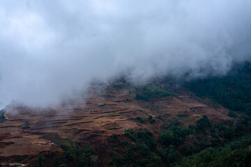 misty fog over village in mountains