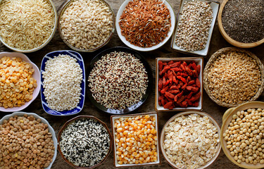 Variety kinds of dry organic white and brown cereal and grain seed on grunge background