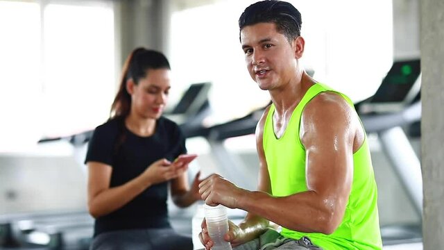 sportsman taking a break after training at the gym sitting and drinking water
