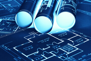 Blue-white construction drawings on the table. The concept of construction, architecture, design,...