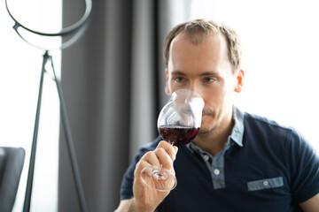 Man Drinking Wine In Video Conference