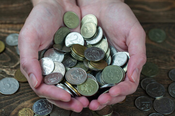 coins in the palms, Russian money, the concept of savings