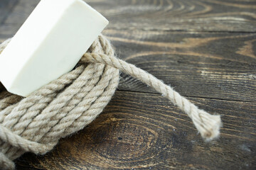 rope with soap on a wooden background, the concept of suicide