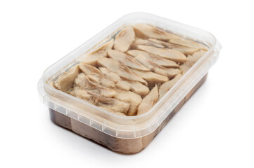 Opened plastic container with salted herring in oil. Isolated on white.