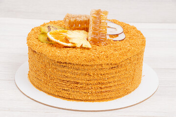 Cake, honey cake with honeycomb on a white background for the holiday