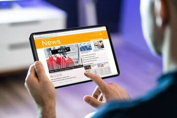 Man Using Tablet Computer Reading Electronic News