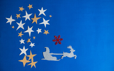 Christmas decoration, Christmas tree made with star and Santa riding on deer sled in blue...