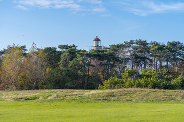 A brick lighthouse with a bright blue sky in the background. Picture of Falsterbo Lighthouse built in 1796, Scania, Sweden