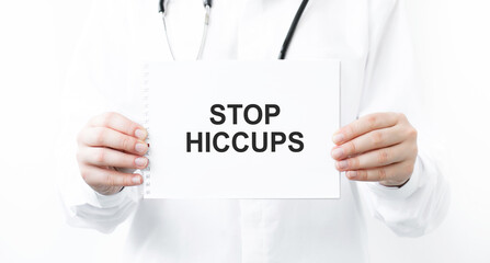 Doctor holding a card with text STOP HICCUPS, medical concept