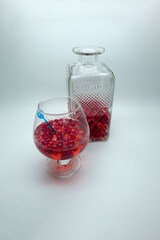 Homemade tincture of red cherry. Berry alcoholic drinks concept. Homemade red wine made from ripe cherries in a glass bottle