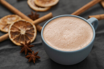 Hot chocolate in a blue cup with natural christmas decorations