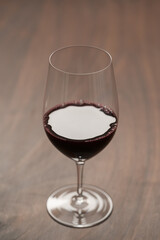 Red wine in wineglass on black walnut table
